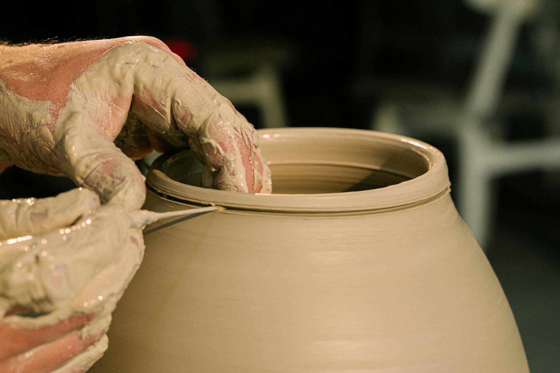 close up shot of a person molding a pot